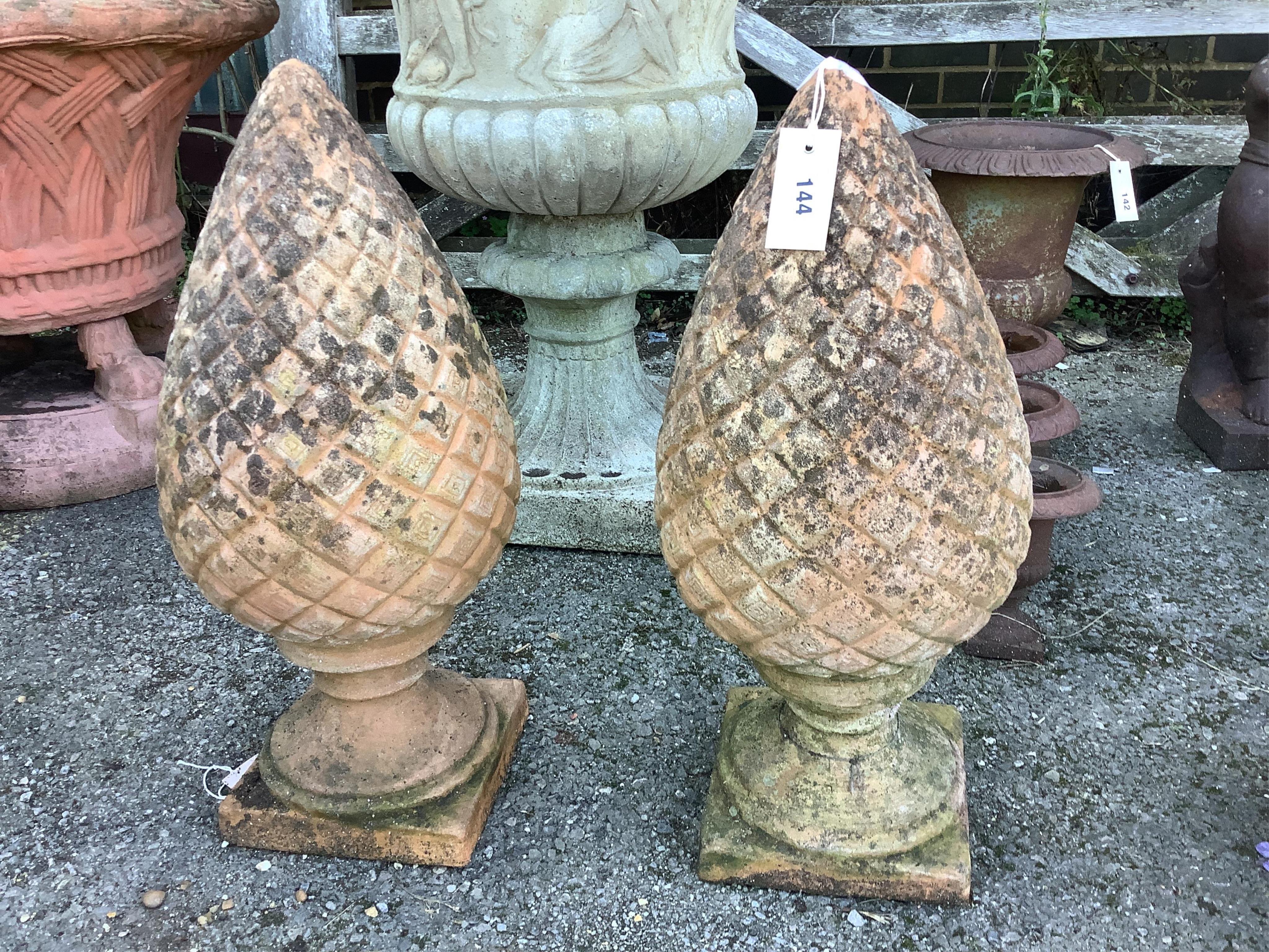 A pair of terracotta pineapple finials, height 56cm. Condition - fair